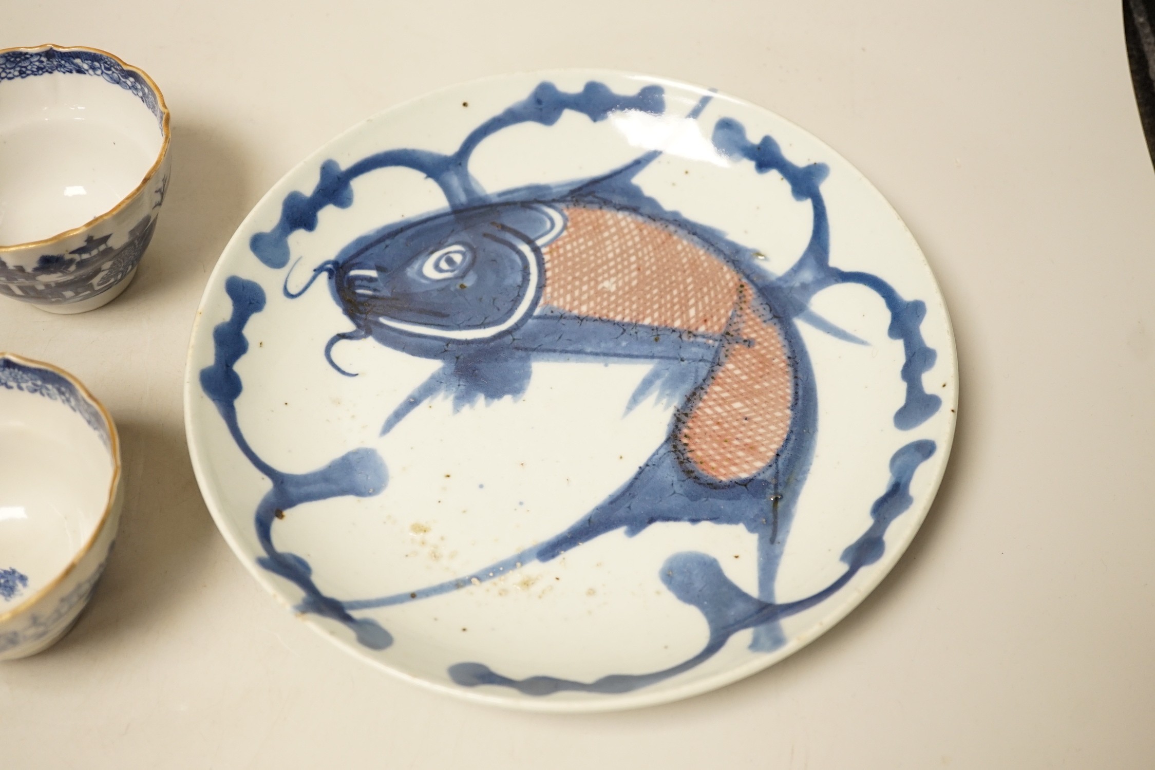 Two 19th century Chinese blue and white dishes and two 18th century tea bowls, largest 23cm diameter